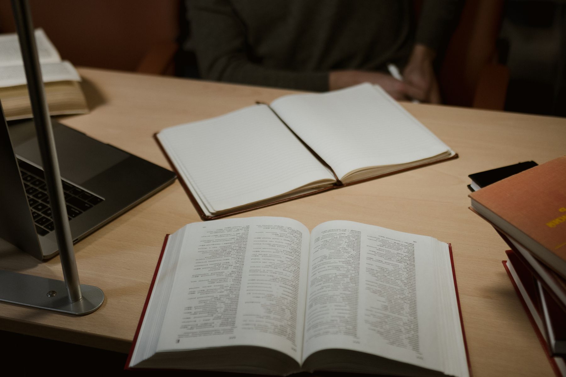 A notebook and study materials arranged on a desk